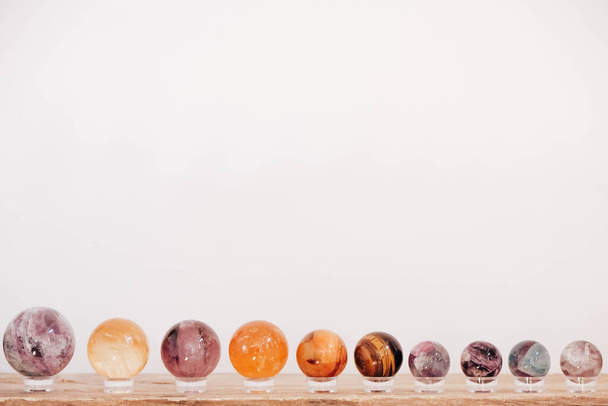Crystals in the form of balls on a wooden table. Copy, empty space for text. - Photo, Image