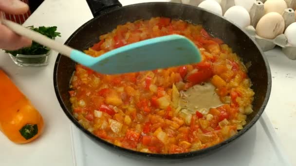Σεφ μαγείρεμα τηγανητά αυγά shakshuka σε σάλτσα λαχανικών στο τηγάνι. Εβραϊκή και αραβική κουζίνα. Συνταγή Shakshuka. Διαδικασία εργασίας του μαγειρέματος. Κοντινό πλάνο. - Πλάνα, βίντεο