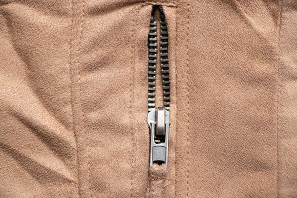 zipper on brown fabric as background close-up - Photo, Image
