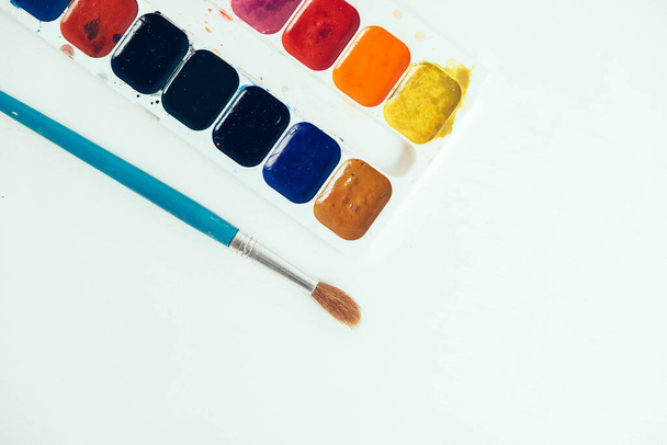 Set of watercolor pain and brushes for painting on a white background. Top view. Copy, empty space for text. - 写真・画像