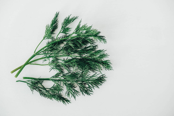 Fresh green dill on a white wooden background. Top view. Copy, empty space for text. - Fotoğraf, Görsel