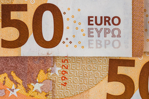 Παγκόσμια ιδέα χρήματος, μακροεντολή λεπτομερής σε ένα τραπεζογραμμάτιο των 50 ευρώ, μακροεντολή φωτογραφία του νομίσματος του ευρώ - Φωτογραφία, εικόνα