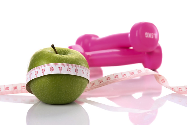 Tape measure with apple and pink dumbbels - Zdjęcie, obraz