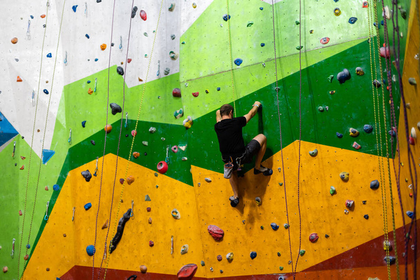 A rock climbing wall for background practical wall in gym - Photo, Image