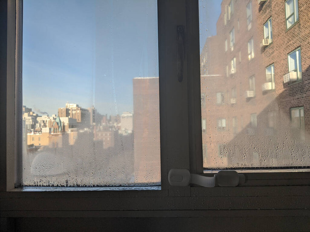 Cold room interior looking out onto water condensation formed on interior windows during early winter. Condensation is known to cause damp and mold - Photo, Image