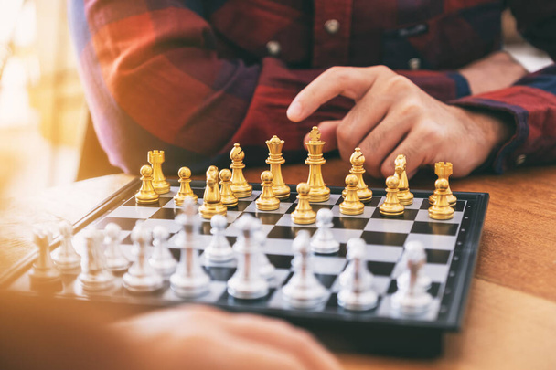 Closeup image of a man moving and playing chessboard game together - Photo, Image