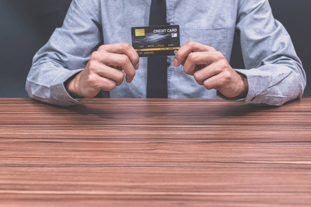 A man holding a credit card - Photo, Image