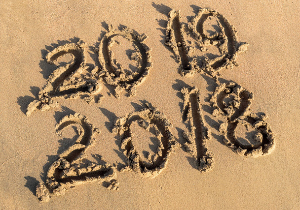 Koncepcja nowego roku 2019. Napis 2018 i 2019 na piasku plażowym. - Zdjęcie, obraz