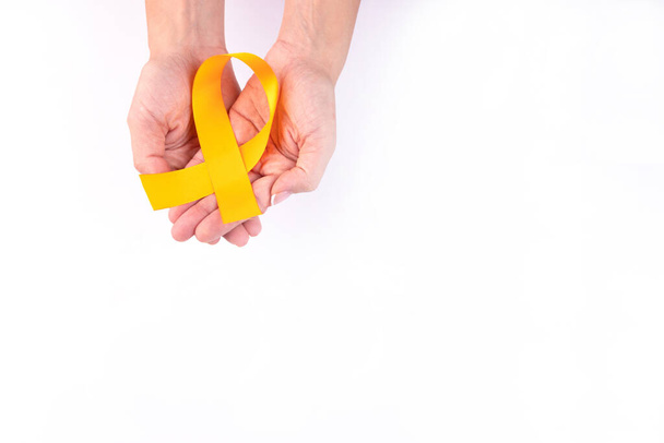 Orange ribbon in female hands. Leukemia Awareness. Healthcare and medicine concept. - Foto, imagen