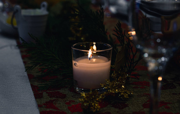 Dekoratif bir masanın üzerindeki yanan mumların romantik ışığıyla yakın plan.. - Fotoğraf, Görsel