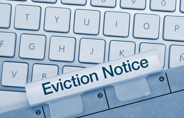 Eviction Notice Written on Blue Key of Metallic Keyboard. Finger pressing key. - Photo, Image