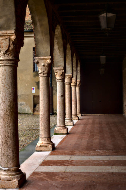 Porchway of an ancient building in a square in Italy - Photo, Image