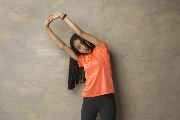 Portrait of fit and sporty young asian woman doing stretching - Photo, Image