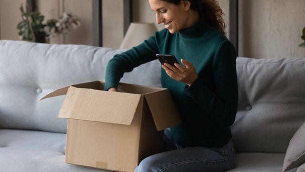 Excited woman unbox package shopping online on cell - Fotoğraf, Görsel