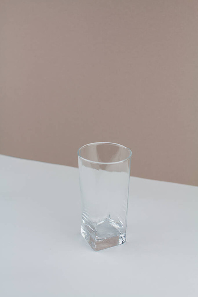 a glass cup on white brown background stylish in the kitchen - Foto, afbeelding