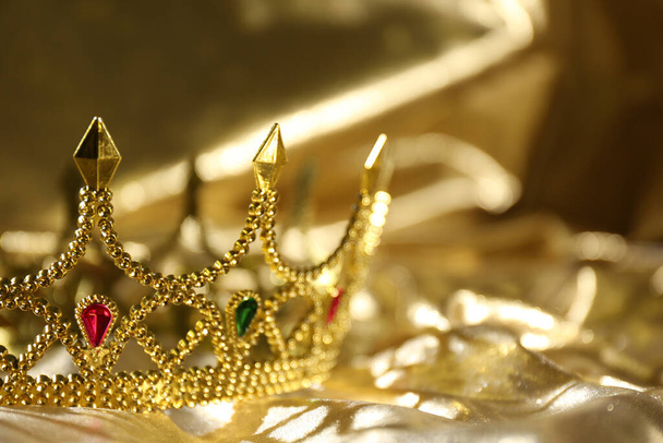 Beautiful ancient crown on golden fabric, space for text. Fantasy item - Fotoğraf, Görsel