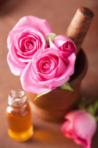 mortero con flores de rosa y aceite esencial para aromaterapia y
  - Foto, imagen