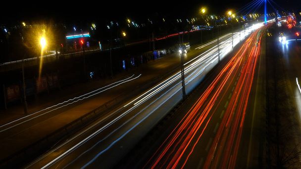 A long exposure shot of car lights on the road at night - Photo, image