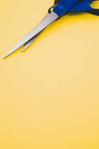 A couple of scissors isolated on a yellow background - Fotografie, Obrázek