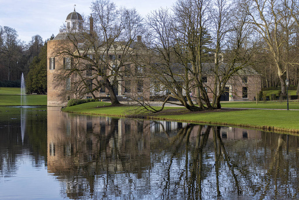 Rosendael castle with barren winter trees in front reflection in the still water of the garden pond in the foreground - Фото, зображення