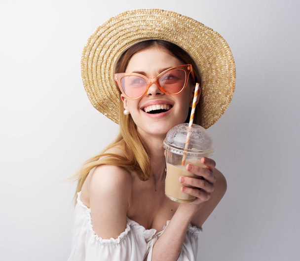 Cheerful woman in pink glasses hat glass with drink fun model - 写真・画像