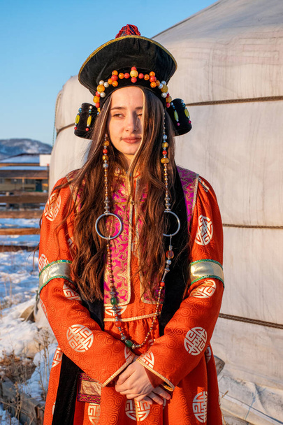 Ulan-Ude, Russia - Feb 2020: Young people in traditional buryatian clothes near buryatian yurt. - Foto, Imagen