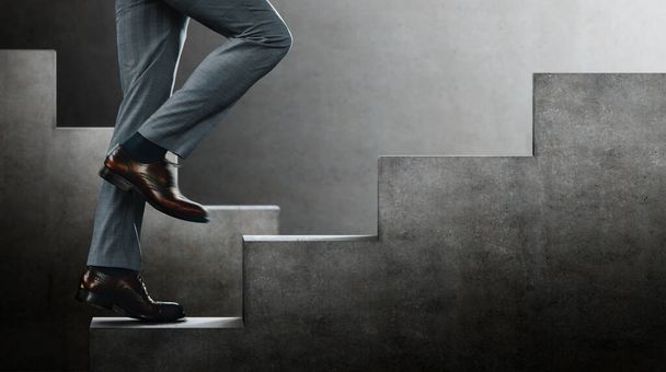 Motivation and challenging Concept. Steps Forward into a Success. Low Section of Businessman Walking Up on Staircase. Sureal place - Photo, Image