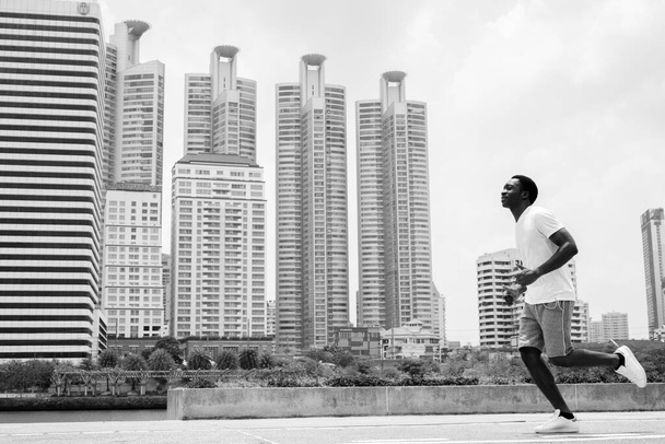 Young handsome African man exercising at the park - 写真・画像