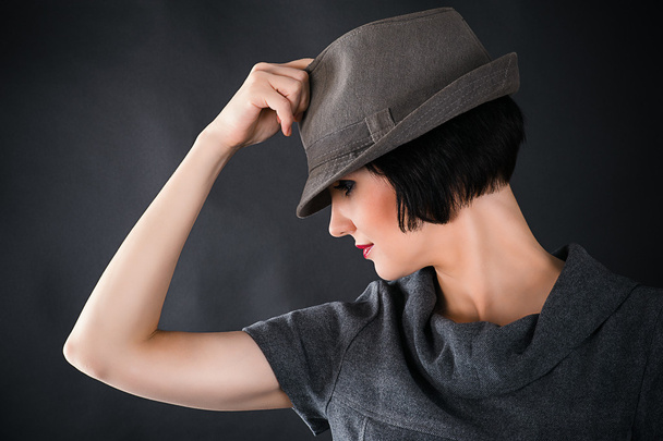 Face of a beautiful woman in a male hat - 写真・画像