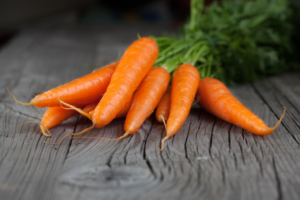 Carrots on a wooden background - Photo, Image