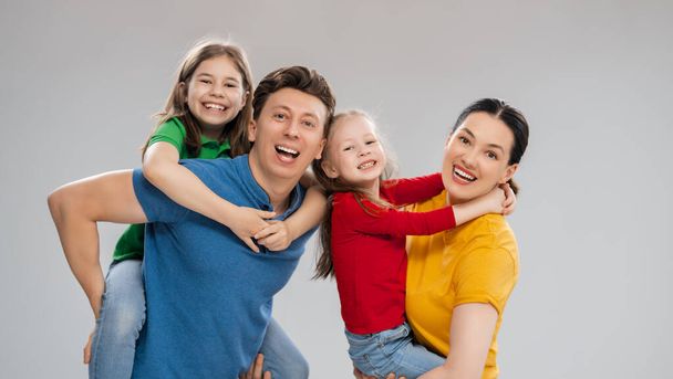 Happy loving family. Mother, father and children daughters on white background.  - Valokuva, kuva