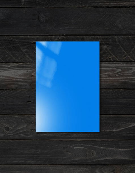 Blue booklet cover isolated on black wood background, mockup template - Zdjęcie, obraz