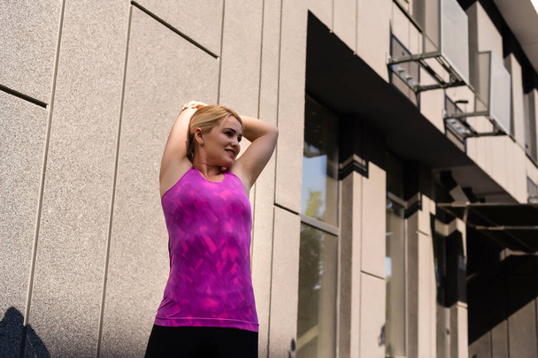 Fitness sport woman in fashion sportswear doing yoga fitness exercise in the street, outdoor sports, urban style - Φωτογραφία, εικόνα
