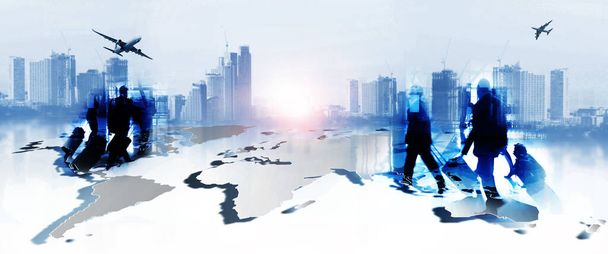 Silhouettes of business people walking  against a modern cityscape or airport . Toned image double exposure  - Photo, Image