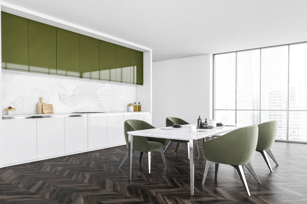 White and green minimalist kitchen, white table and green chairs near window with city view, side view. Modern new kitchen on dark parquet floor, 3D rendering no people - Fotografie, Obrázek