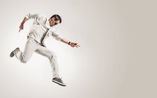 Portrait of a handsome, talented dancer making a dance move - Fotó, kép