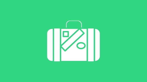 Valkoinen matkalaukku matka- ja tarroja kuvake eristetty vihreällä taustalla. Matkalaukkukyltti. Matkatavaroiden kuvake. 4K Video motion graafinen animaatio - Materiaali, video
