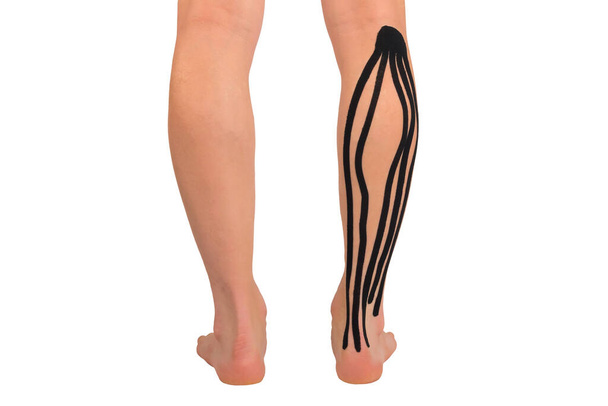 fixing leg muscles with medical tape, isolated on white, back view - Zdjęcie, obraz