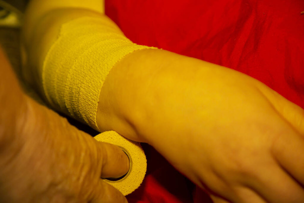 Close up of a woman having her arm bandaged - Photo, Image