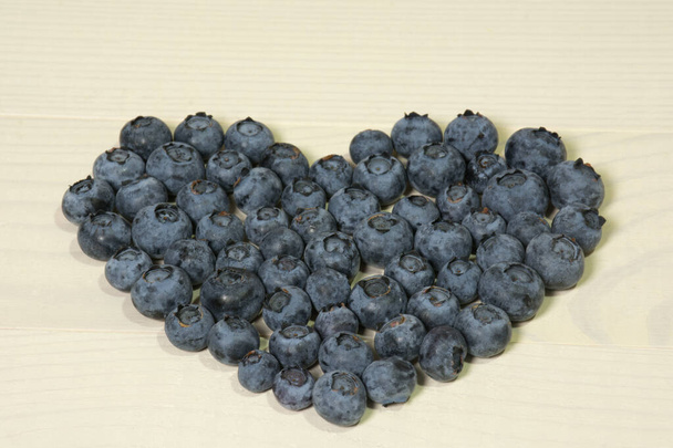 Blueberries summer berry on wooden table. Fresh organic antioxidant ecologic food. Vitamin C, E, P, PP, B carotene flavonoids ascorbic acid - Photo, Image