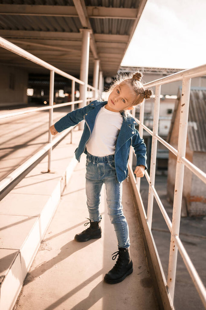 Girl in denim clothes dancing hip-hop in the car parking - Photo, Image