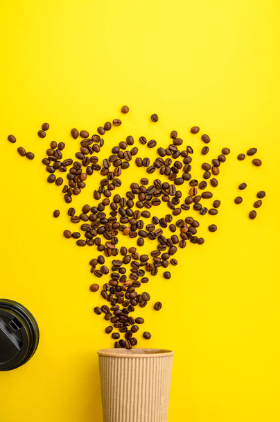 Coffee bean flowers isolated on yellow background, top view. Organic vegetarian food, grocery assortment, natural eco products, healthy lifestyle concept - Photo, Image