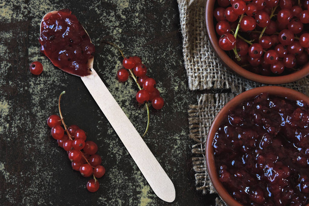 Homemade redcurrant jam. Fresh berries of red currant. Concept cooking jam. - Photo, image