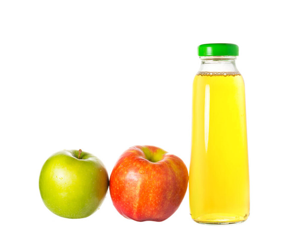 glass bottle with apple juice and two red and green apples. harvest concept, healthy food and healthy lifestyle. isalated on white. - Photo, Image