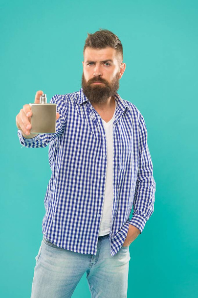mature male hipster using perfume fragrance from bottle, selective focus, perfumery. - 写真・画像