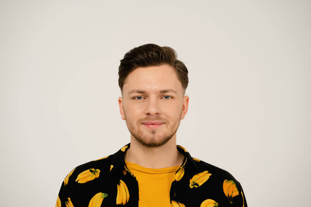 Close up portrait of handsome man in banana shirt looking at camera isolated on white background - Фото, зображення