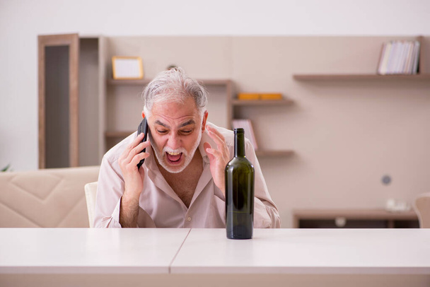 Old man drinking alcohol at home - Photo, Image