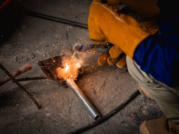 Shielded metal arc welding (SMAW), also known as manual metal arc welding (MMA or MMAW), flux shielded arc welding, or informally as stick welding. At an actual construction site. - Foto, Imagem