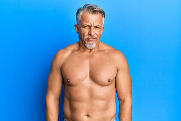 Middle age grey-haired man standing shirtless skeptic and nervous, frowning upset because of problem. negative person.  - Fotó, kép
