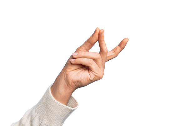 Hand of caucasian young man showing fingers over isolated white background snapping fingers for success, easy and click symbol gesture with hand - Photo, image